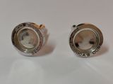 two silver cuff rings with a coin in the middle of them