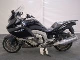 a picture of a black motorcycle parked in a garage