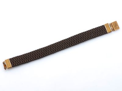 un bracelet de montre noir et doré avec un fermoir doré