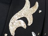 a close up of a black jacket with silver sequins on it