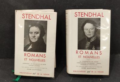 two books on a table with a black and white photo of two men
