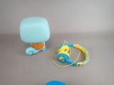 a blue and yellow toy and headphones on a table