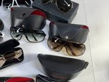 many pairs of sunglasses sitting on a table next to a case