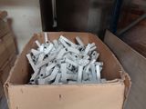a cardboard box full of pieces of metal in a room