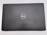 the dell laptop is sitting on a table with its lid open