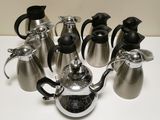 a group of coffee pots and tea kettles sitting on a table