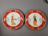 two plates with a painting of a woman and a man on them