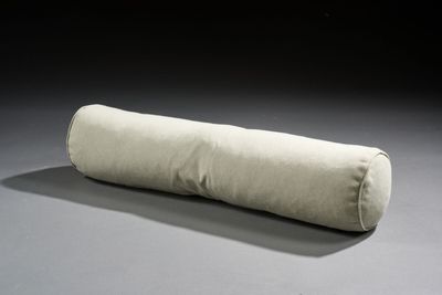 a long pillow that is sitting on the floor