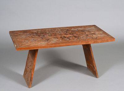 an image of a wooden table with a carved design on it