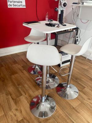 a white table with two chairs and a computer on it