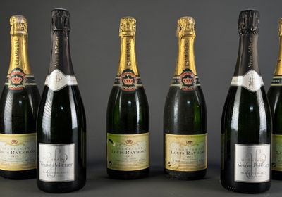six bottles of champagne lined up in a row on a table