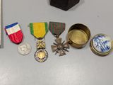 many medals and medals on a table next to a book