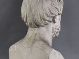 a close up of a bust of a man on a gray background