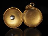 an image of a close up of a gold locke with a diamond in it