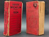 two red books sitting on top of each other on a table