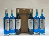 four bottles of blue blend sit in front of a wooden box