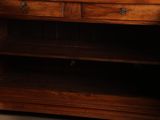 a wooden cabinet with a mirror on top of it
