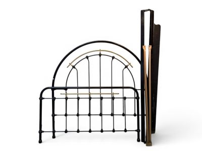 a bed with a metal frame and umbrellas on it