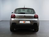 the back of a silver citrole parked in a white room