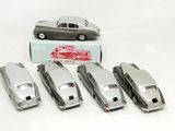 six silver model cars are lined up in a row in front of a box