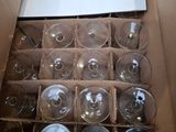 a box of wine glasses and a box of empty wine glasses