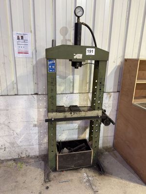 a machine that is sitting on the ground in front of a building
