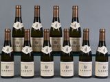 six bottles of wine are lined up in a row on a table