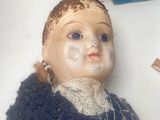 a doll that is sitting on a table next to a book