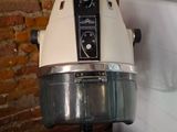 a white blender sitting on top of a black bowl