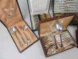 a lot of silverware in a box on a table