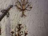 a clock on the wall with a pair of scissors hanging on it