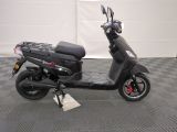 a scooter that is parked on a checkered floor