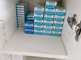 many boxes of toothpaste on the shelf in the bathroom
