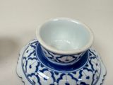 a small blue and white bowl on a saucer