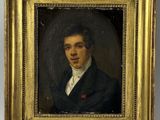portrait of a young man in a black suit and white shirt