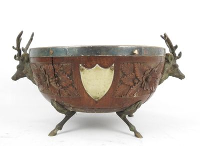 an image of a metal bowl with deer heads and a shield on it