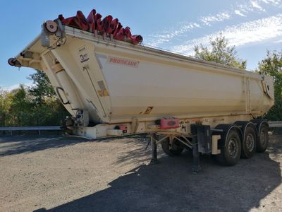 a large white dump truck parked on the side of the road