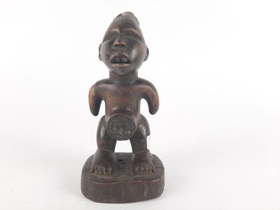 an old wooden statue of a man holding a baby