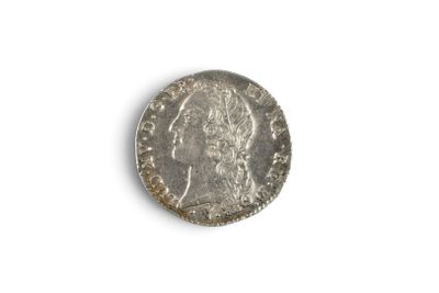 a close up of a silver coin on a white surface