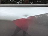 a reflection of a man in the window of a car