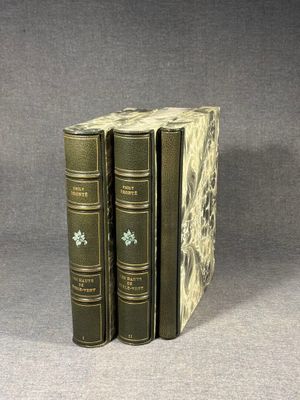 three books are stacked on top of each other on a table
