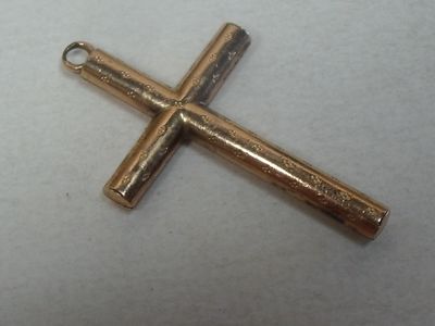 two gold crosses on a white surface with a white background