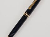 the pen is black and gold with a gold trim