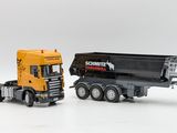 two toy trucks that are next to each other on a white surface
