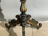 an image of a black and gold table on a tiled floor