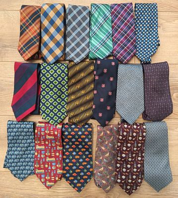a close up of a pile of ties on a wooden surface