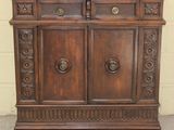 a wooden cabinet with two doors and two drawers