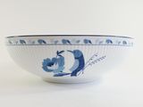 a blue and white bowl on a white table