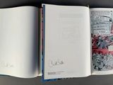 an open book that has a picture of a man on it