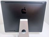 an apple computer monitor sitting on top of a white table